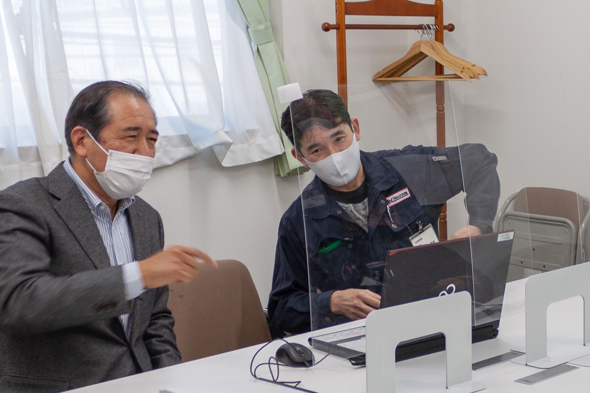 Two colleagues reviewing a system together at a desk